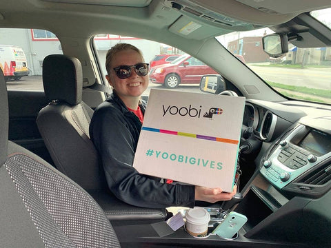 woman in car with Yoobi classroom pack
